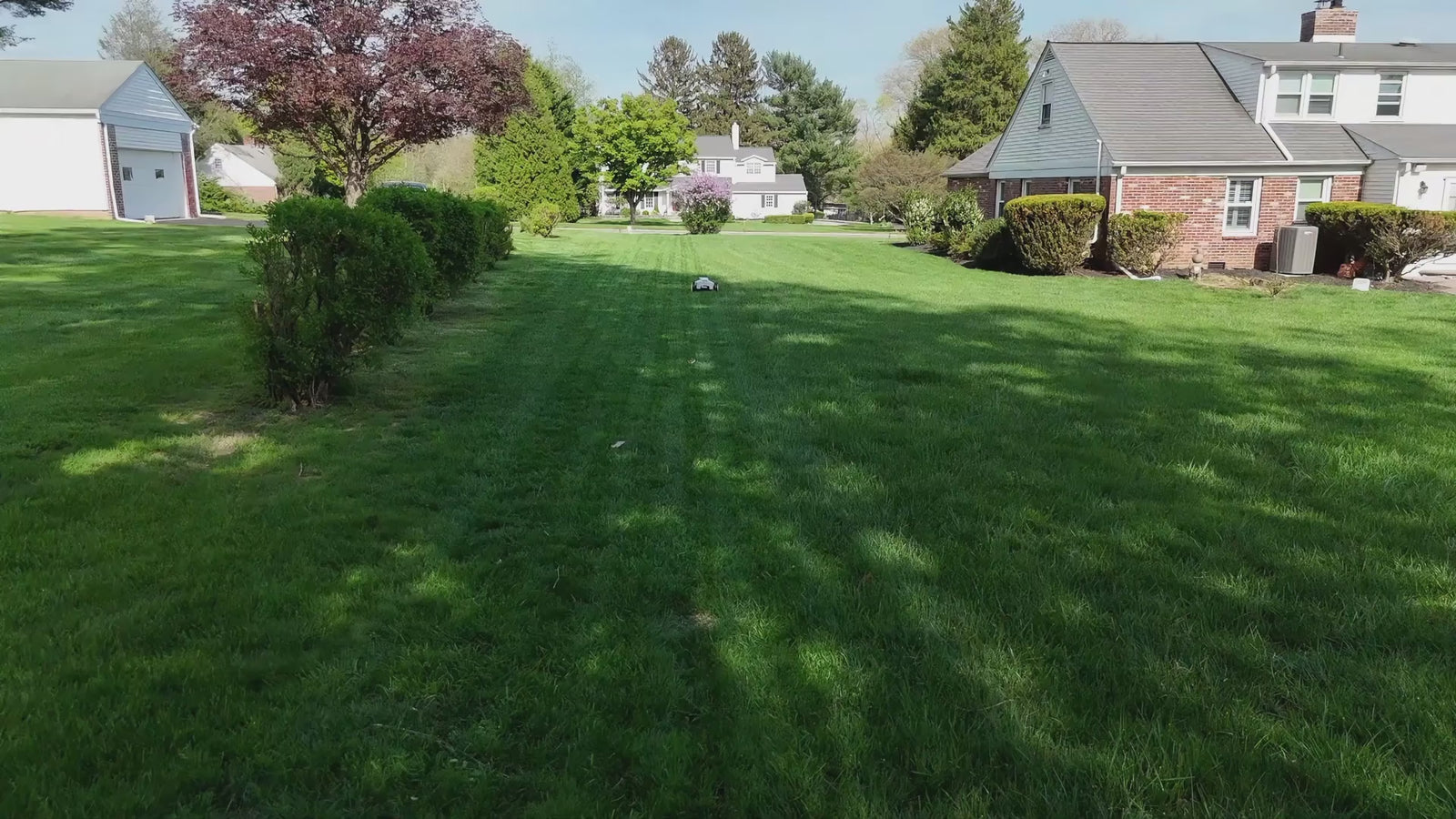 Aerial view of a robot lawn mower working on the lawn.
